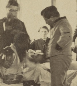high resolution detail image of Armoury Squarre Hospital photo showing what appears to be doctors treating an amputee. From high resolution scans, we are able to see like never before, the individual suffering of those in images such as this